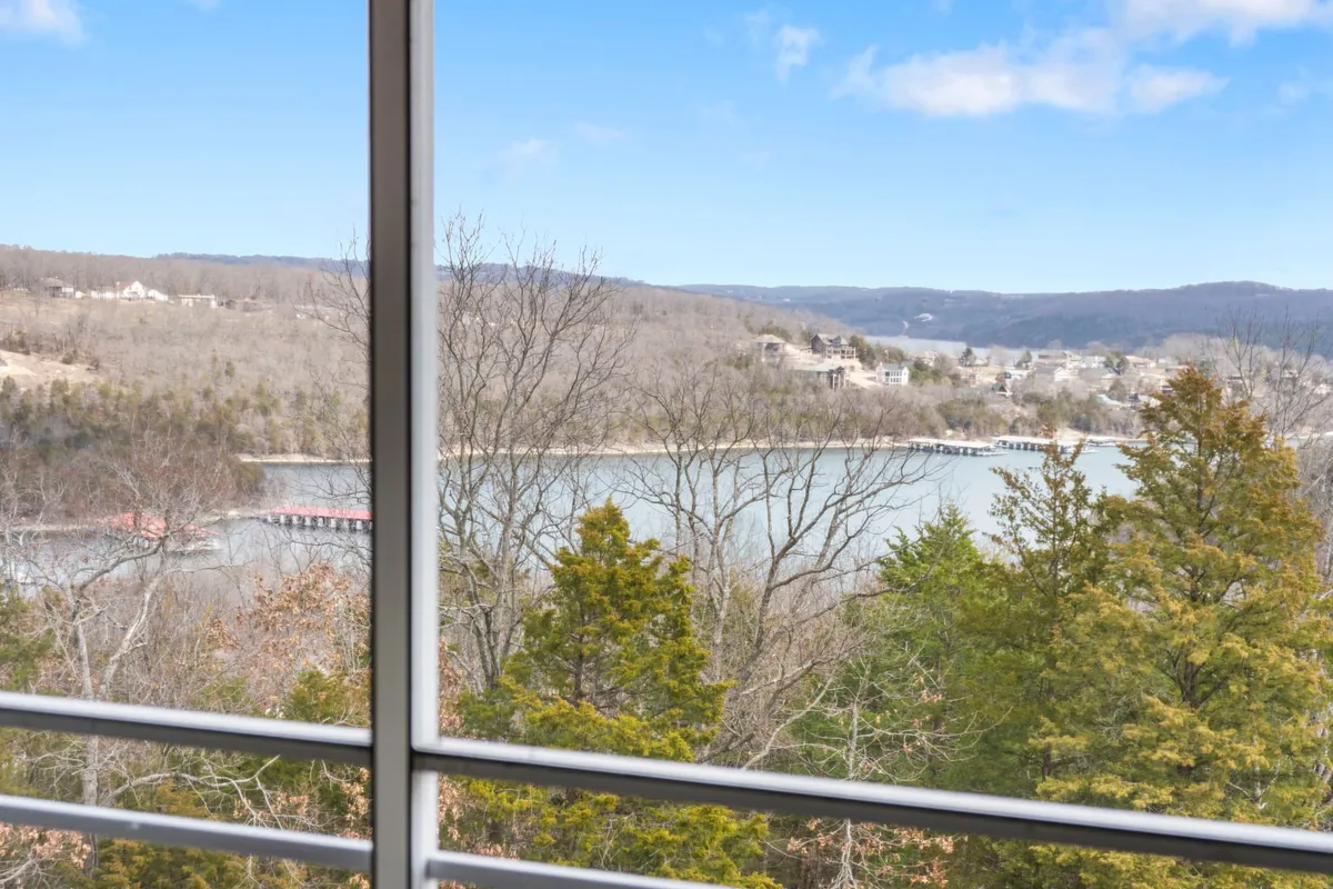A tranquil vista overlooking the expansive lake, with tree-lined hills and a pristine shoreline—an inviting space for morning strolls, lakeside exploration, or simply soaking in the serenity.